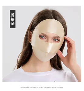 Detailed view of champagne gold silk sun mask with satin finish and ear loops