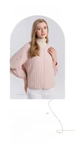 Detail of light pink V-neck silk padded jacket featuring quilted fabric and button closure