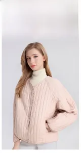 Detail of light pink silk padded V-neck jacket with vertical quilting and snap buttons