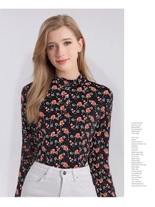 Detail of floral silk blouse showing the elegant ruffle stand collar and button closure