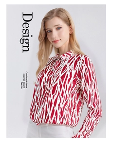 Detail of silk long-sleeved shirt with red and white abstract pattern and lapel collar