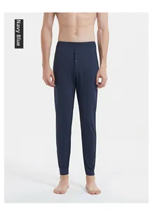 Detail of navy blue thermal pants featuring an elastic waist and single-button fly design