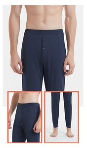 Detail view of men's thermal silk pants featuring single-button fly and elastic cuffs