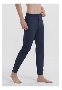 Close-up of deep blue silk thermal pants featuring elastic waist and button fly
