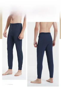 Detailed front and back views of men's slim fit navy thermal pants with button fly details