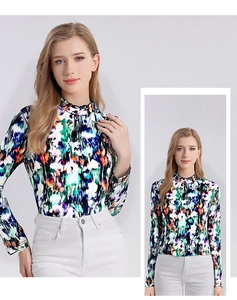 Detail of elegant ruffled stand collar and abstract silk print on a long sleeve shirt