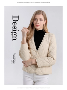 Detail einer beige gesteppten Jacke mit V-Ausschnitt, Rautenmuster und Knopfverschluss