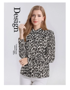 Detail of silk-like long sleeve blouse with black and white abstract letter print
