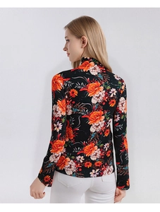 Detail of colorful floral print on soft black merino wool high-neck sweater for women