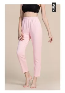 Detail of pink silk thermal knit trousers featuring a high-waist elastic band and soft texture