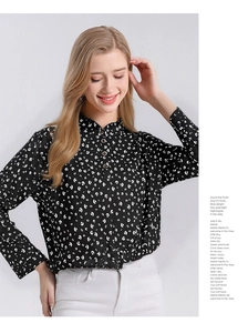 Detail of silk long sleeve blouse featuring white crescent print and stand collar