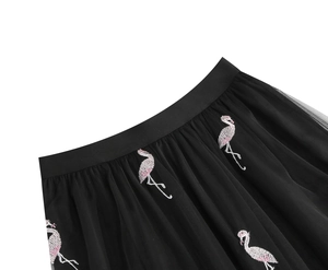Close-up of pink flamingo embroidery on black pleated tulle high waist mesh skirt
