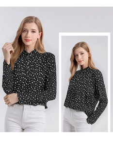 Detailed close-up of a women's black silk shirt featuring white crescent moon patterns