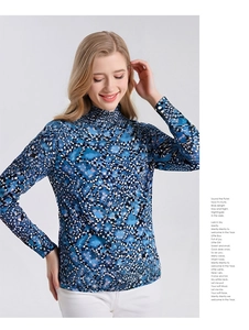 Close-up of mock turtleneck collar with abstract dark blue floral pattern on fine wool top