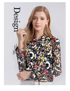 Detail of premium silk shirt featuring vibrant graffiti print and classic lapel collar