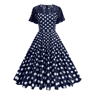 Close-up of navy blue polka dot dress with delicate lace patchwork on the neckline