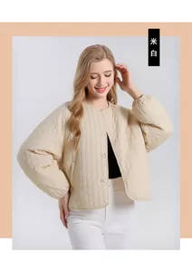 Detailed view of beige silk-filled quilted jacket with diamond patterns and snap buttons