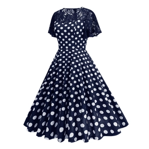 Detailed view of the lace patchwork and vintage polka dot pattern on the navy dress