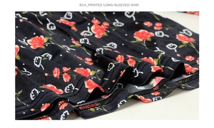 Detailed macro view of the mulberry silk printed fabric with red rose floral patterns