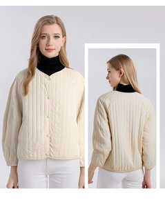 Detailed vertical stripe quilting on a cream silk-filled V-neck cardigan jacket