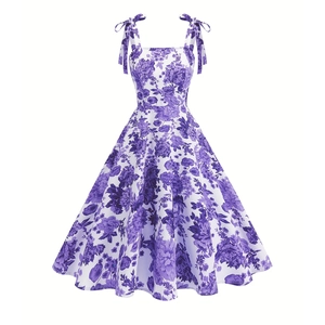 Detail of floral A-line dress featuring purple flower print and bow-tie shoulder straps