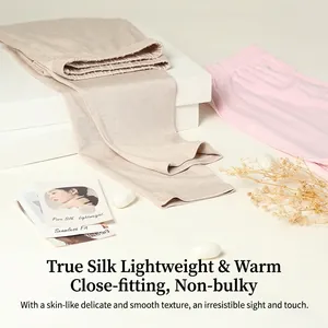 Silk thermal pants for women in beige and pink displayed on a minimalist white stand