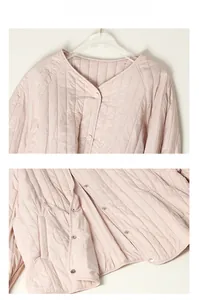 Detail view of pink quilted mulberry silk jacket featuring V-neck and button closure