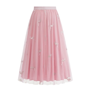Detail of pink tulle skirt featuring delicate flamingo embroidery and elastic high waist