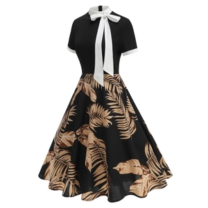 Detail of vintage 50s Hepburn style dress with white bow collar and leaf print