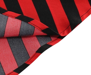 Close-up of red and black striped skirt hem showing high-quality stitching and fabric texture