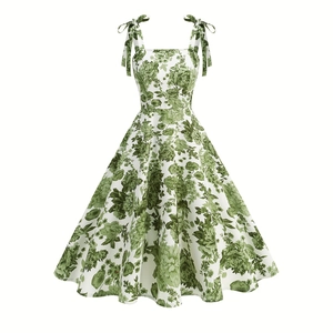 Close-up detail of green floral print on vintage high waist dress with tie shoulder straps