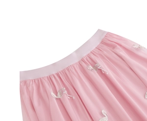 Close-up of pink tulle skirt featuring delicate flamingo embroidery and elastic waistband