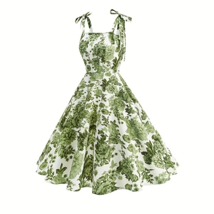 Detail of floral print dress showing adjustable bow tie shoulder straps and vintage patterns