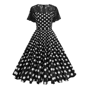 Detail of polka dot dress featuring elegant lace patchwork on sleeves and neckline