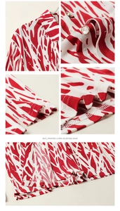 Detailed macro view of silk long sleeve shirt featuring red abstract print and metal buttons