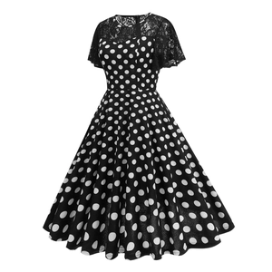 Close-up of black and white polka dot dress with elegant black lace stitching detail