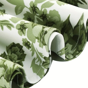 Close-up of high-quality stitching and green floral print on the summer dress hemline