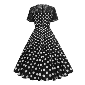 Close-up of black lace patchwork and white polka dot pattern on an elegant dress