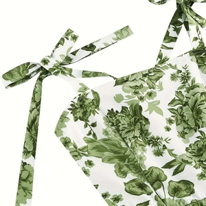 Detail of floral printed dress featuring adjustable self-tie bow shoulder straps