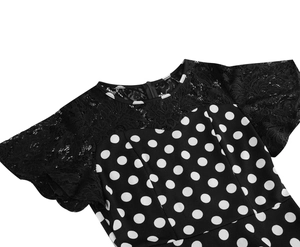 Close-up of neckline showing lace patchwork and white polka dot pattern on black fabric