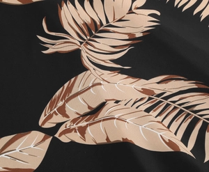 Close-up of tropical palm leaf print on black fabric for summer vintage dress