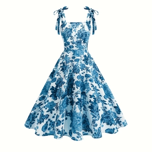 Detailed view of white floral dress with blue flower print and bow tie shoulder straps
