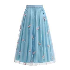 Detailed embroidery of pink flamingos on a light blue mesh A-line skirt with inner lining