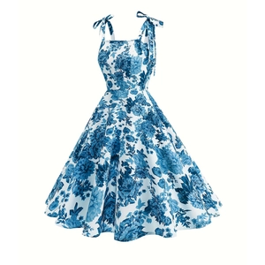 Detail of adjustable bow shoulder straps on a blue floral print swing dress