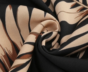 Close-up of vintage print fabric showing abstract leaf pattern and twill weave texture