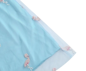 Detailed close-up of pink flamingo embroidery on light blue mesh fabric with lining