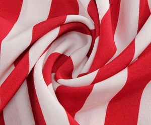 Macro shot of red and white striped fabric texture with soft drape and weave details