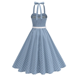 Detail of light blue polka dot dress featuring halter neck bow and elastic shirred back