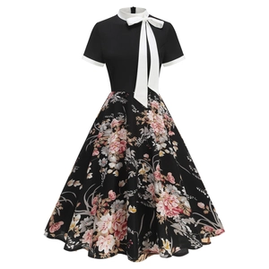 Close-up of retro 50s Hepburn style dress with floral print and white bow neckline