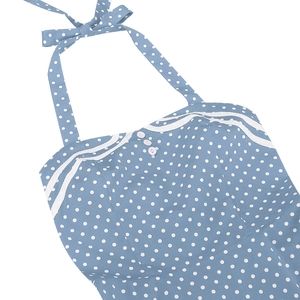 Detailed close-up of light blue polka dot dress neck with white lace trim and buttons